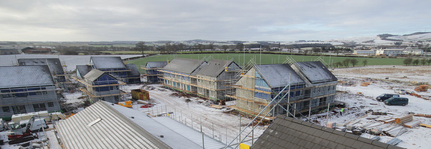 Snow covers a residential housing development construction site in the Scottish Borders